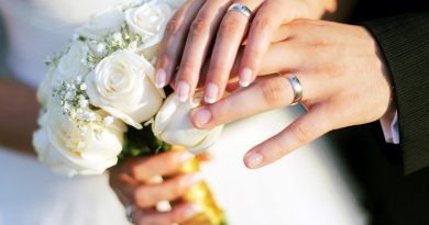 Wedding rings, bouqet and hands holding